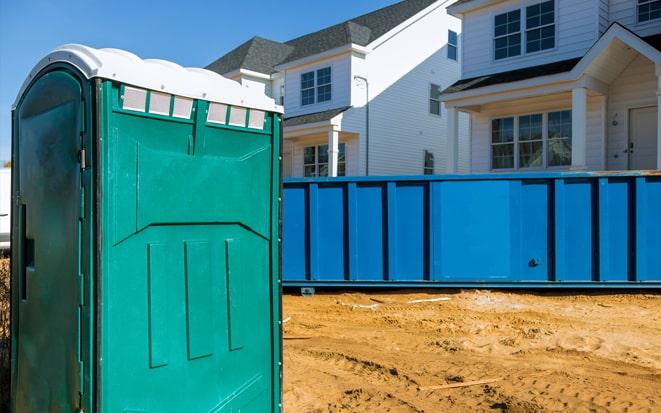 portable toilet and dumpster at a construction site in New Brunswick NJ